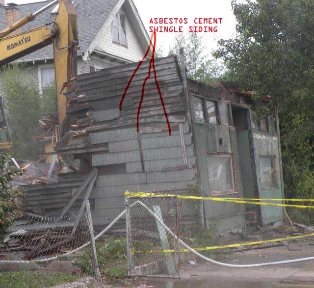 Demolition practice in Cleveland, Ohio - Asbestos Cement shingles just ground up with the debris=public mesothelioma haz.